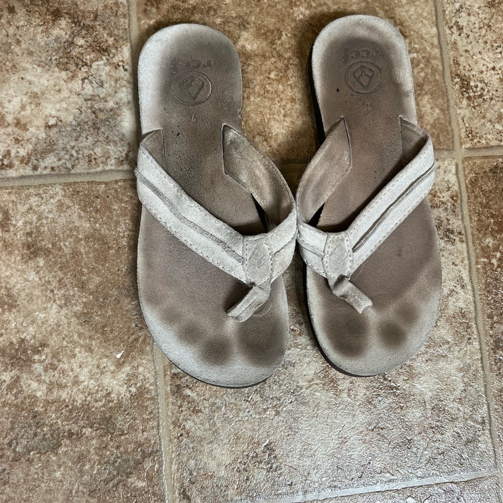 Reef tan suede flip flops.
